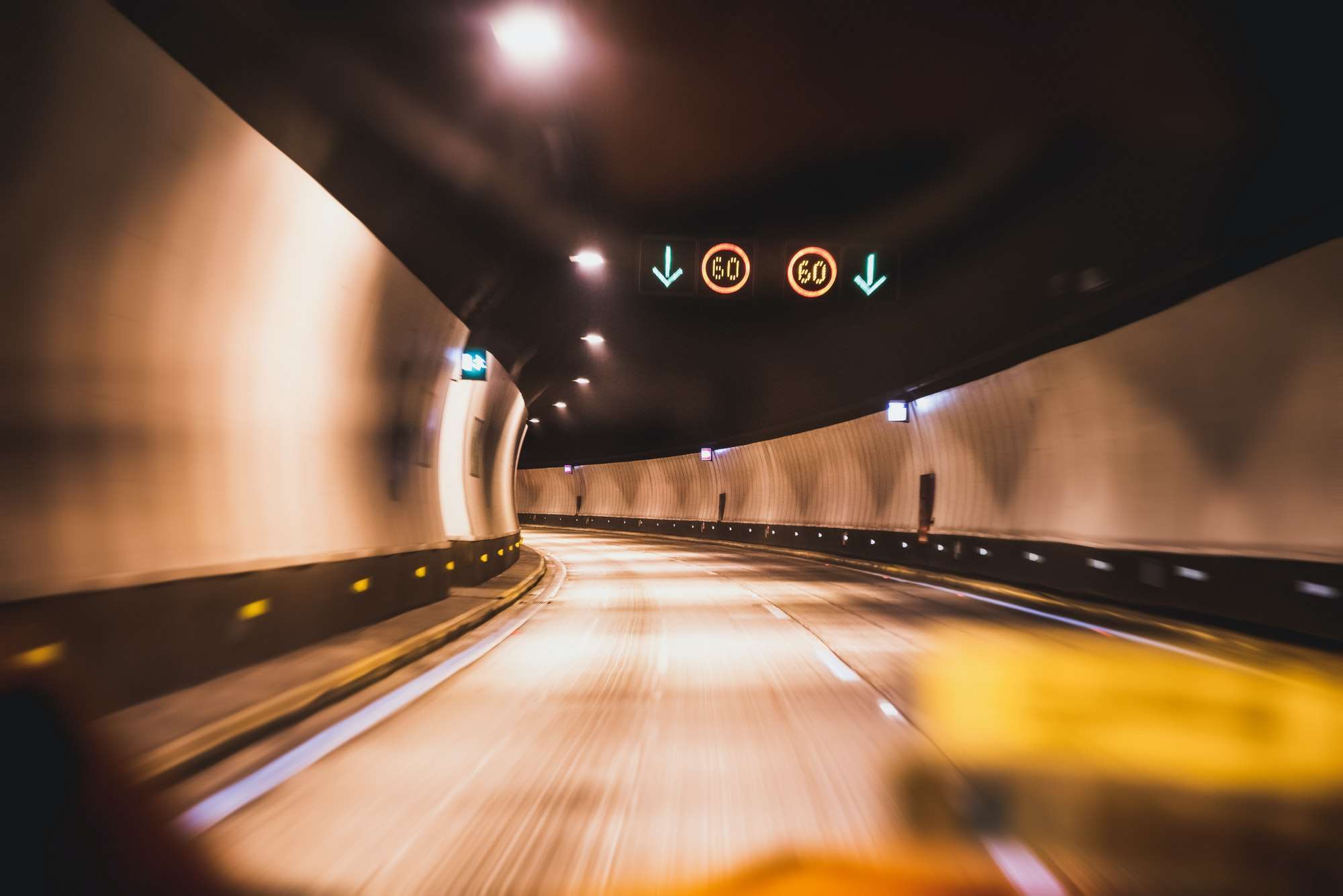 Defocused background of highway road tunnel with yellowish atmosphere