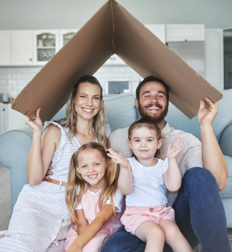 Safety, happy and portrait of family with a roof or covering gesture with cardboard in the living r